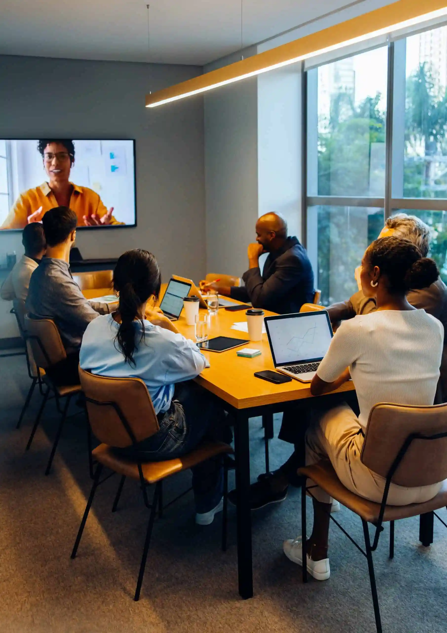 Integrated marketing team meeting with virtual participant discussing data-driven strategy and ROI.